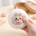 One hand squeezing the personalized Sophia dumpling squishy