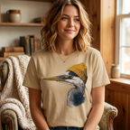 Model wearing a sand beige t-shirt with a great blue heron in a mustard knit beanie graphic
